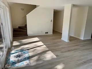 a view of empty room with wooden floor