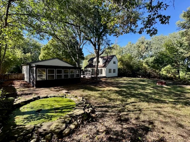 a backyard of a house with table and chairs