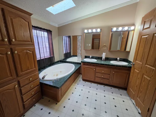 a bathroom with a sink a toilet a mirror and shower