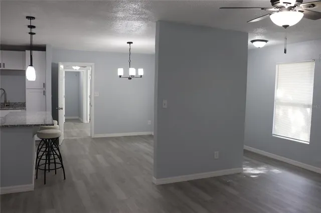 a view of a room with wooden floor and staircase