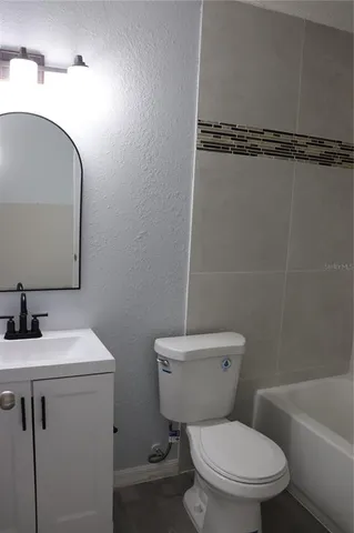 a white toilet sitting next to a bathroom sink
