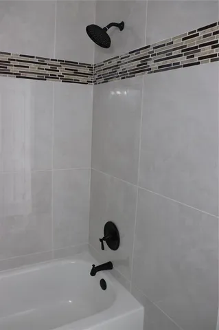 a bathroom with a shower and a window