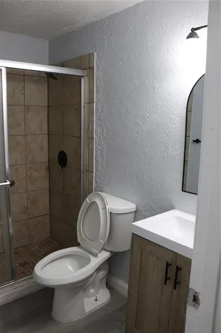 a bathroom with a sink toilet and shower