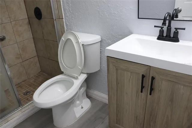 a bathroom with a sink toilet and a mirror