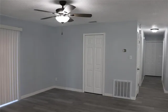 a view of a room with wooden floor
