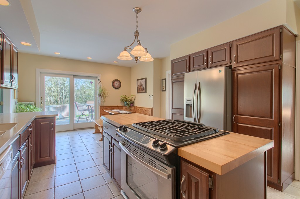 318 Patriots Road Templeton, MA 01468 - Photo 12 of 30 a kitchen with a stove a refrigerator and a sink
