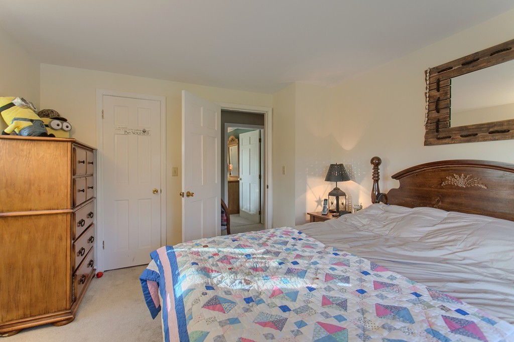 318 Patriots Road Templeton, MA 01468 - Photo 27 of 30 a bedroom with a bed and a mirror