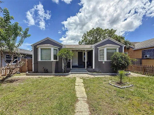 a front view of a house with a yard garage and outdoor seating