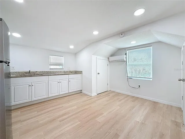 a view of a kitchen with center island and stainless steel appliances
