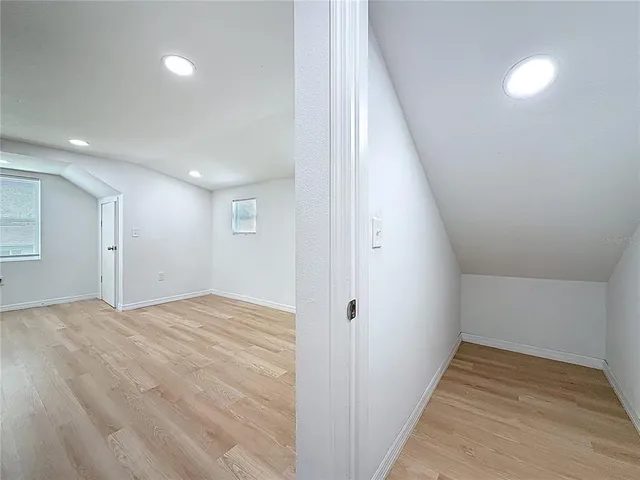 a view of hallway with wooden floor