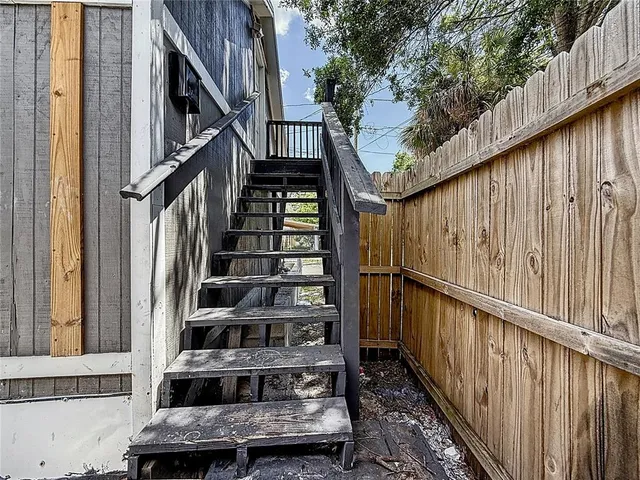 a view of entryway with wooden floor and a front door