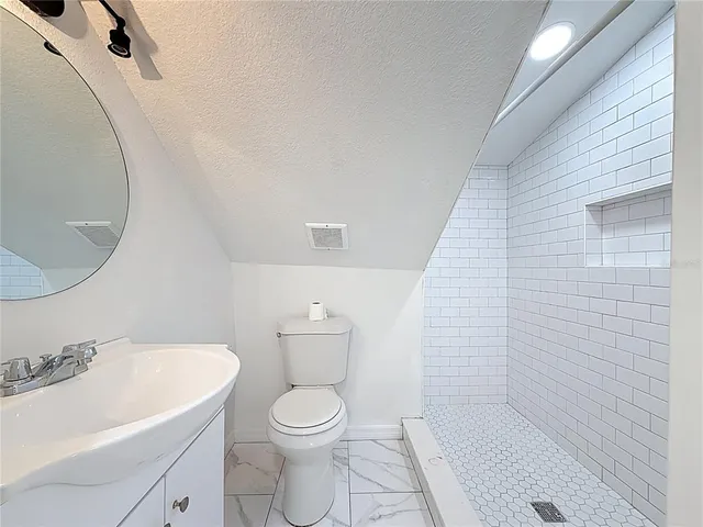 a bathroom with a toilet a sink and bathtub