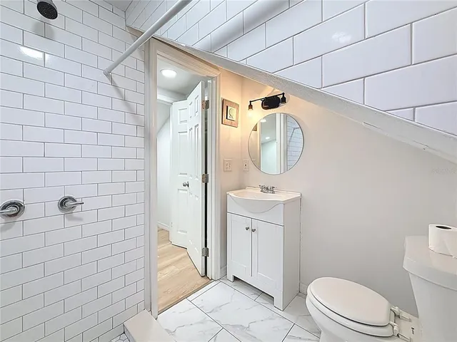 a bathroom with a toilet sink and shower