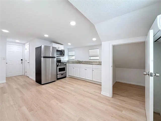 a kitchen with a refrigerator and a sink
