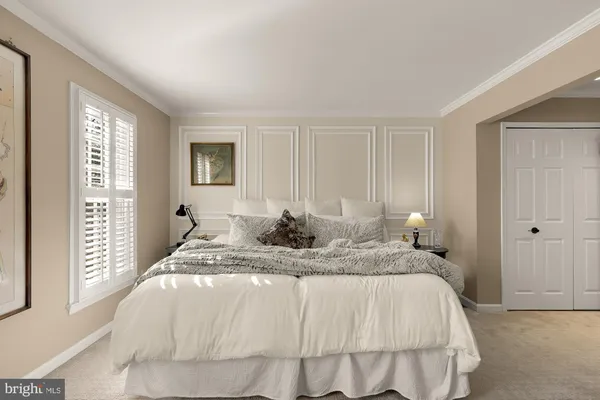 a bed sitting in a bedroom next to a window