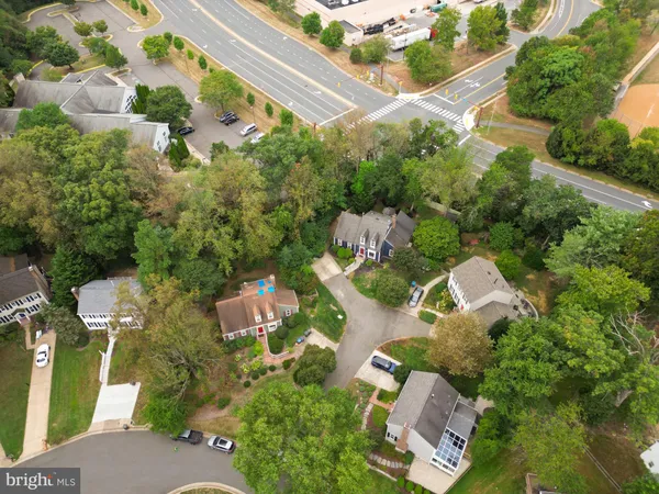 an aerial view of multiple houses with yard