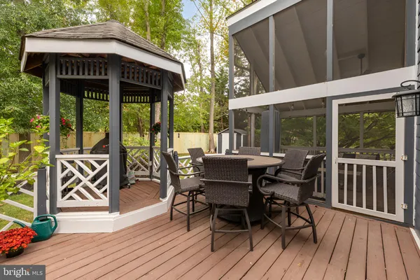 a view of a patio with table and chairs floor to ceiling window with wooden floor
