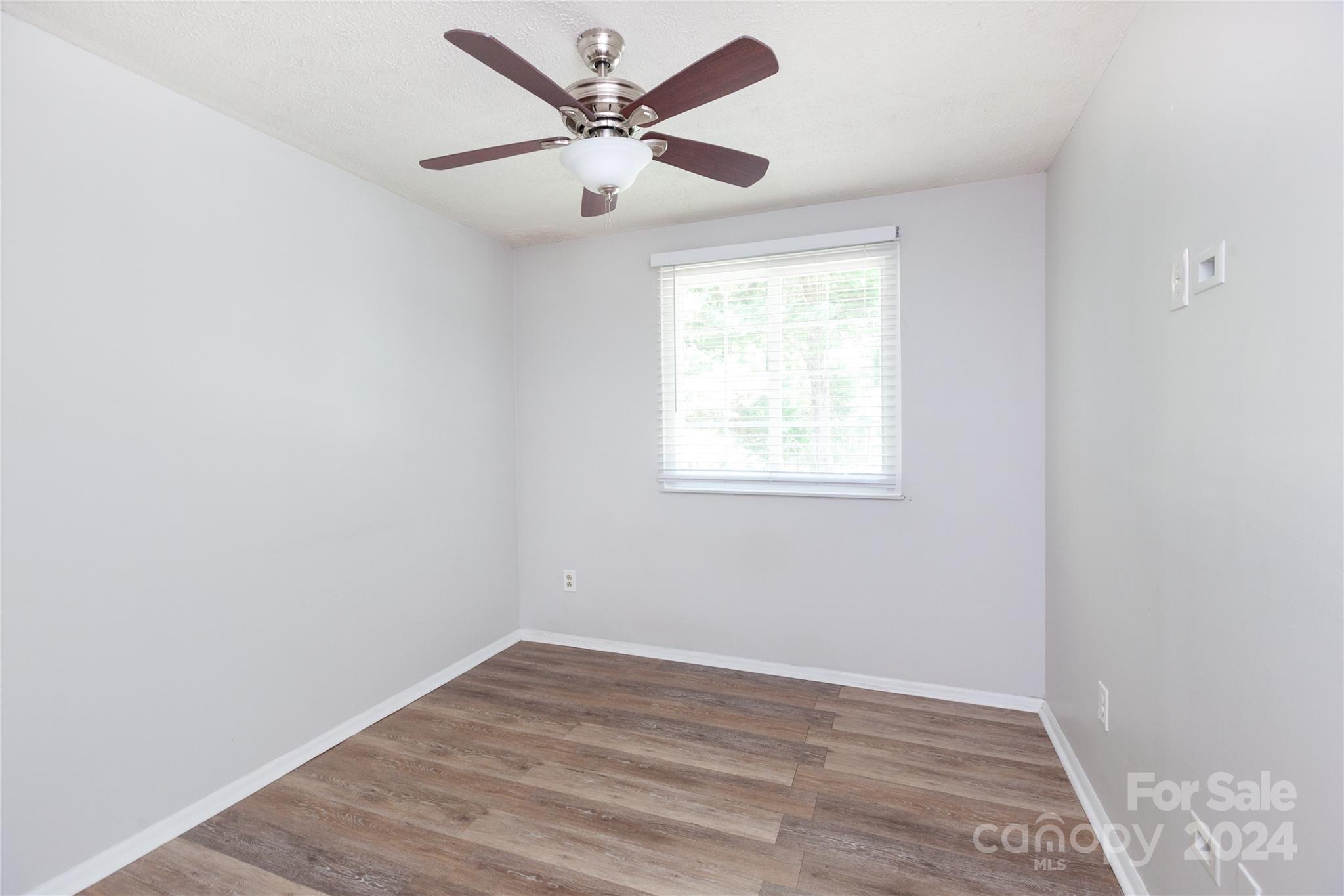 1201 Scaleybark Road, Unit B Charlotte, NC 28209 - Photo 24 of 29 an empty room with wooden floor and windows
