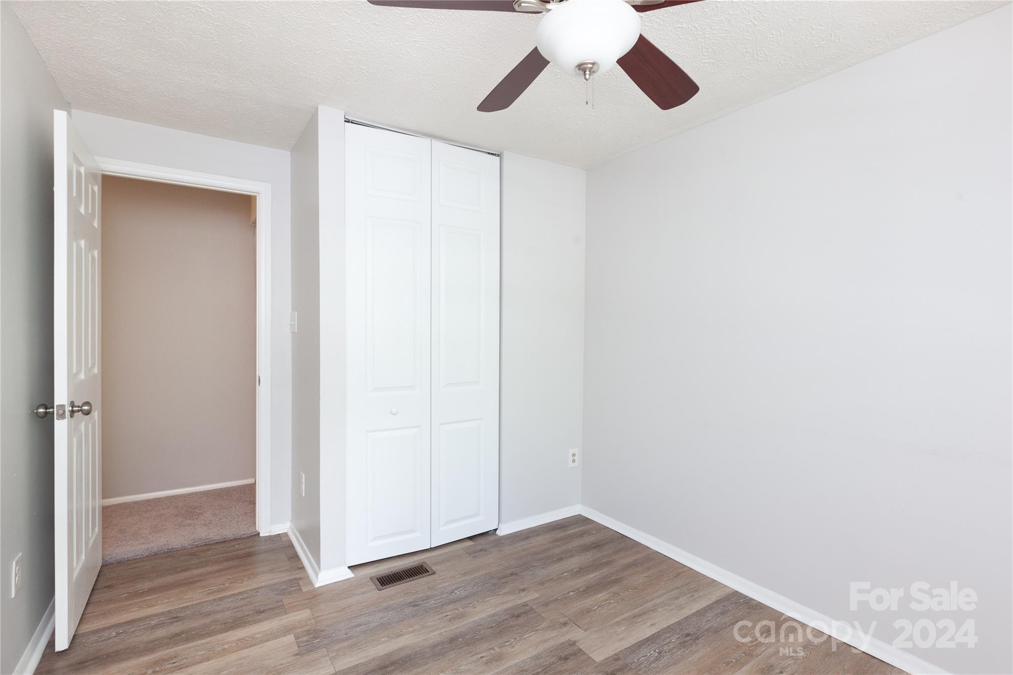 1201 Scaleybark Road, Unit B Charlotte, NC 28209 - Photo 25 of 29 an empty room with wooden floor closet and windows