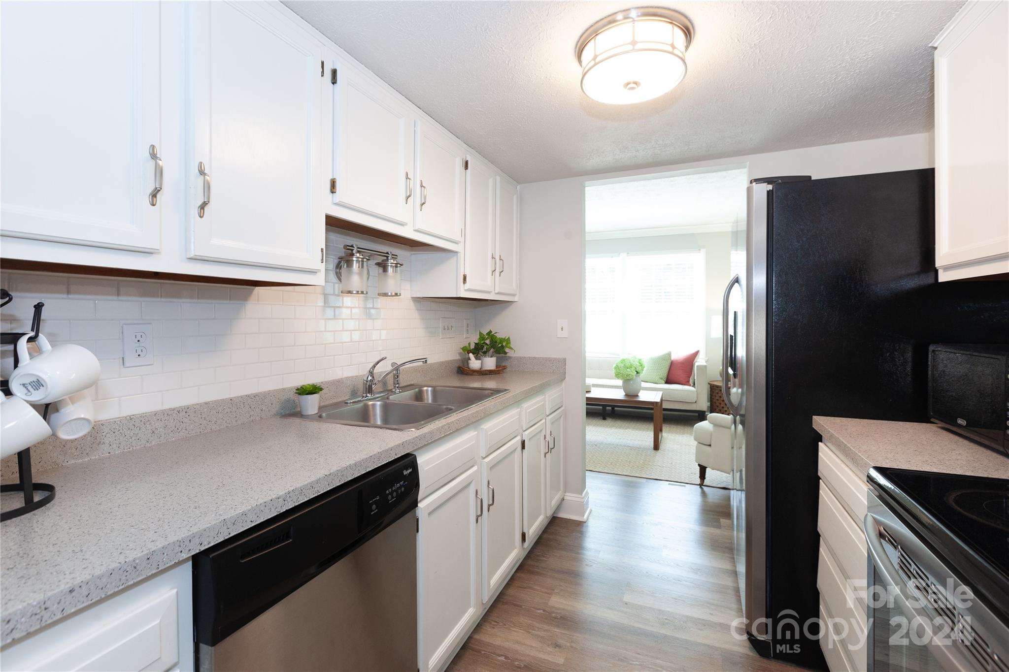 1201 Scaleybark Road, Unit B Charlotte, NC 28209 - Photo 8 of 29 a kitchen with a sink dishwasher a stove and a refrigerator