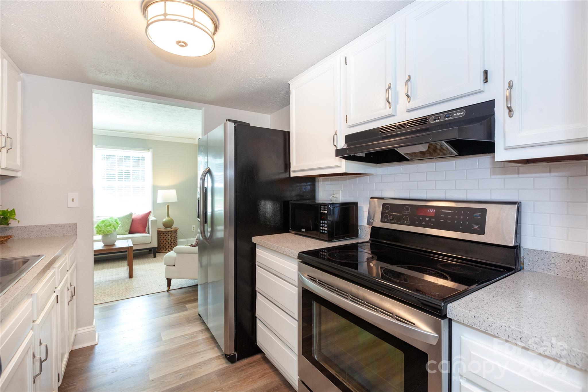1201 Scaleybark Road, Unit B Charlotte, NC 28209 - Photo 9 of 29 a kitchen with a stove and a refrigerator