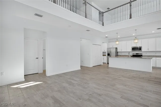 a view of large kitchen with stainless steel appliances cabinets