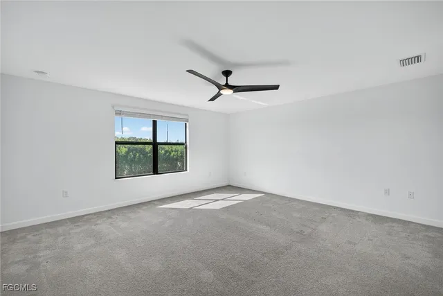 a view of a livingroom with a ceiling fan and window