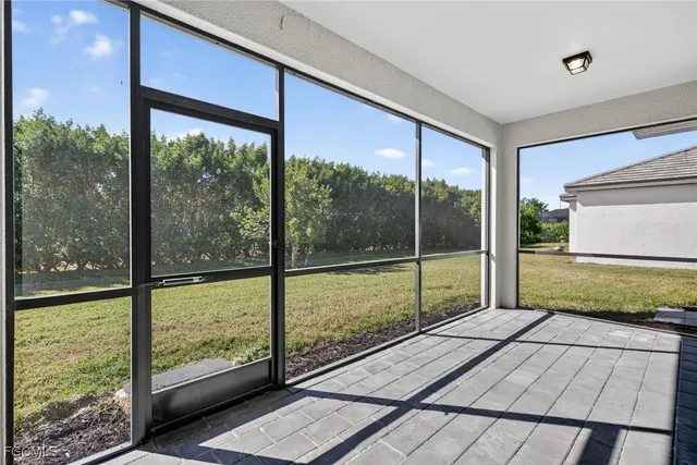 a view of porch with a floor to ceiling window next to a yard
