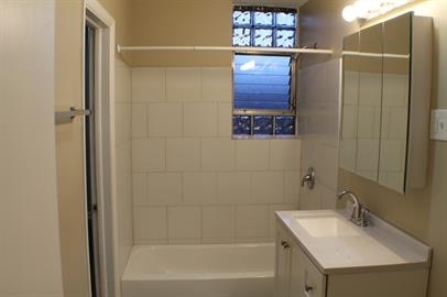 739 Walnut Street, Unit 739 Waukegan, IL 60085 - Photo 5 of 10 a bathroom with a sink and a mirror