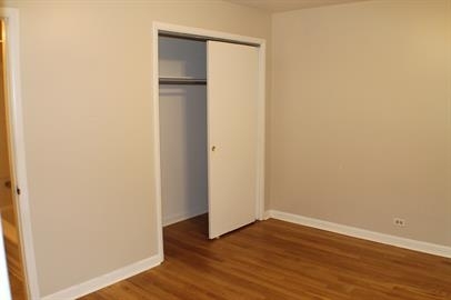 739 Walnut Street, Unit 739 Waukegan, IL 60085 - Photo 7 of 10 a view of an empty room with wooden floor and closet