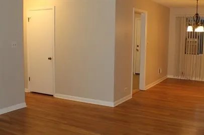 a view of a room with wooden floor