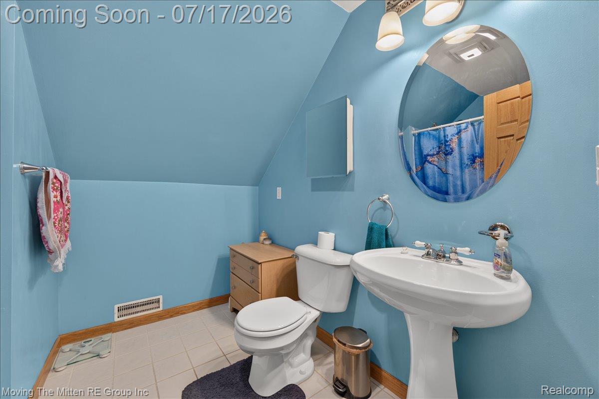 40162 Alden Road Belleville, MI 48111 - Photo 33 of 67 Bathroom featuring a pedestal sink, oval wall-mounted mirror, and tile flooring