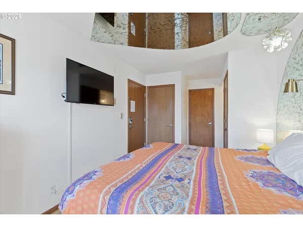 a bedroom with a bed and a flat screen tv