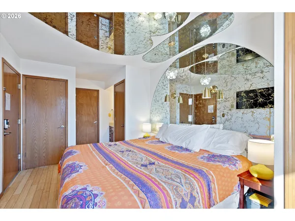 a bedroom with a bed and a chandelier
