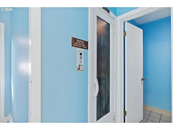 a utility room with stainless steel appliances wooden cabinet and stove top oven