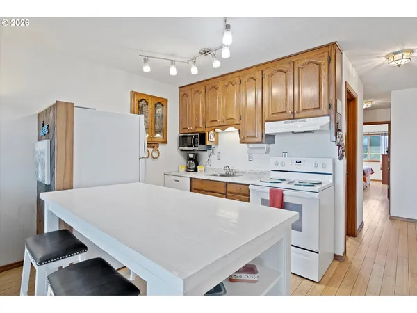 a kitchen with stainless steel appliances kitchen island a cabinets and wooden floor