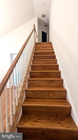 a spacious bedroom with a bed and a chandelier