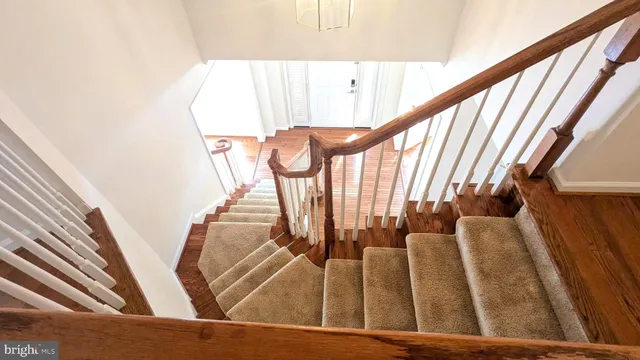 a view of a chandelier fan and entryway