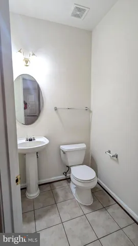 a bathroom with a sink mirror vanity and toilet