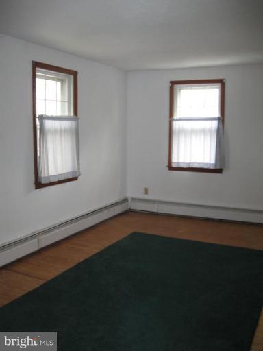 2121 White Hall Road White Hall, MD 21161 - Photo 11 of 20 a view of an empty room with wooden floor and a window