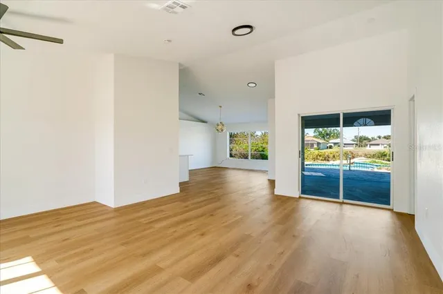 a view of empty room with wooden floor