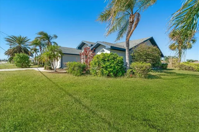 a view of a house with a big yard and potted plants