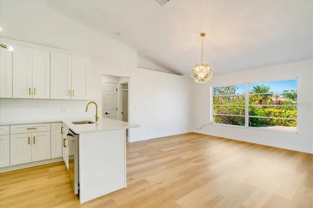 a view of a kitchen with an empty space and a window