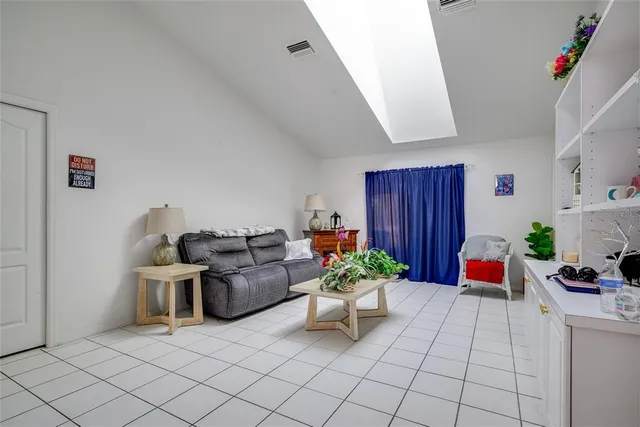 a living room with furniture and flowers