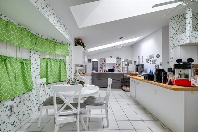 a living room with furniture and kitchen view