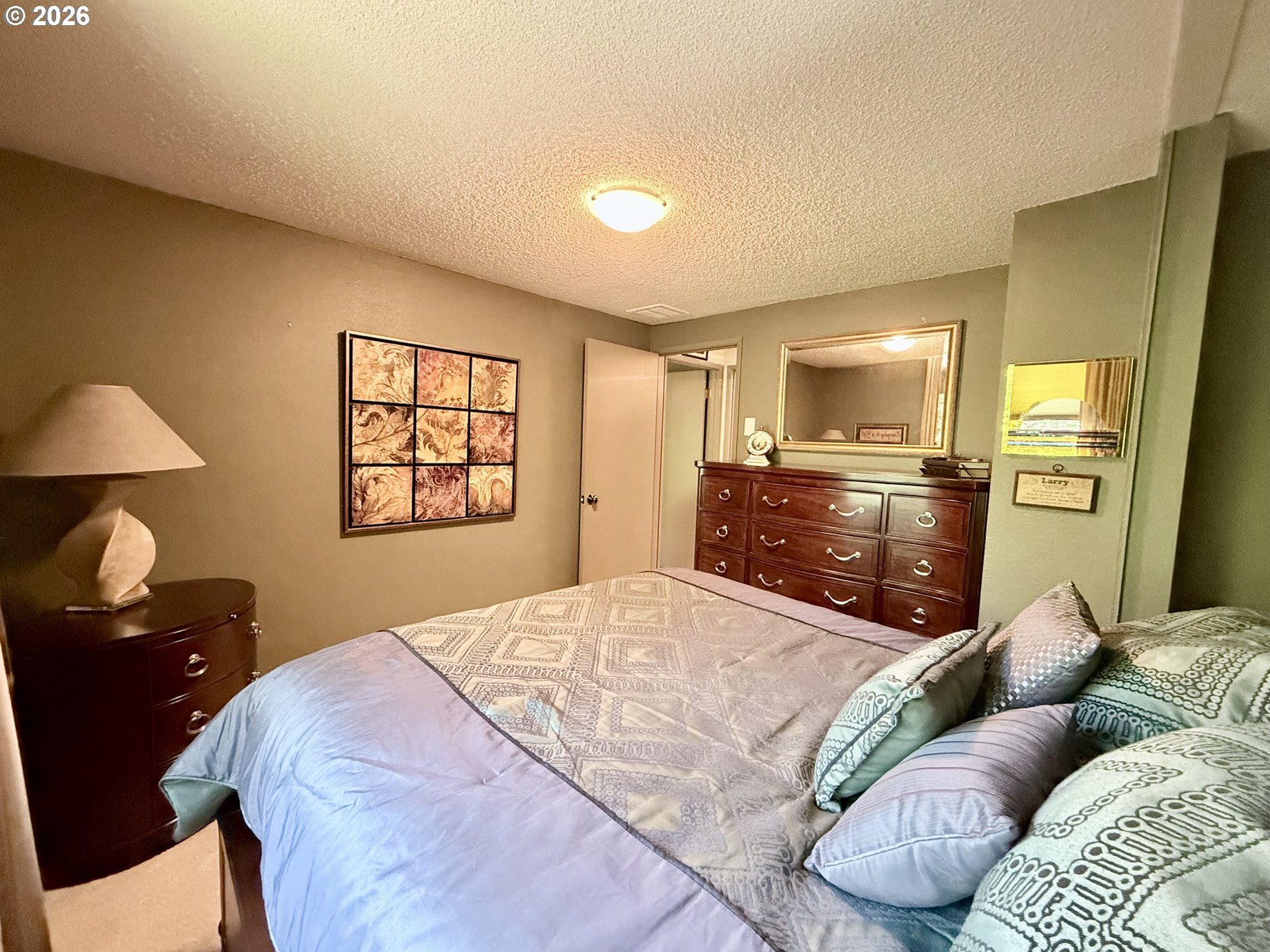 160 Westbrook Way Eugene, OR 97405 - Photo 24 of 31 a bedroom with a bed and dresser with mirror