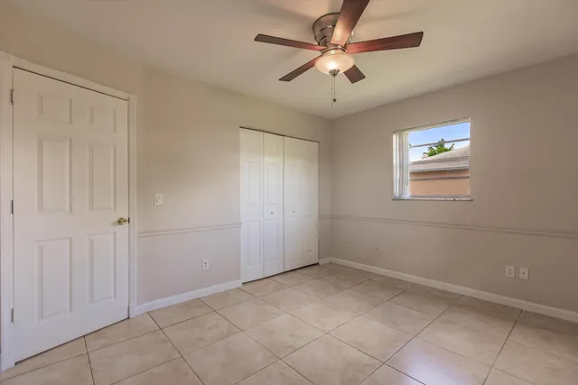 a view of an empty room with wooden floor and a balcony