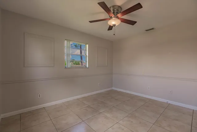 a view of a house with a yard and potted plants