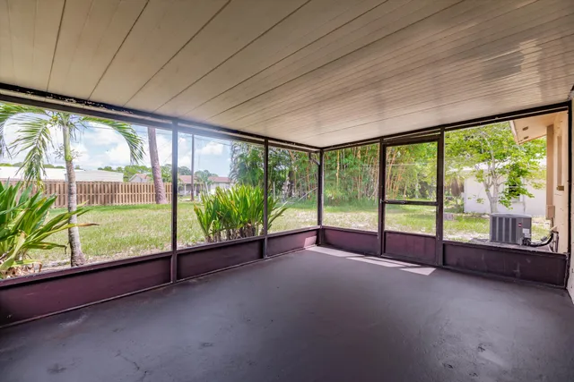 a house view with swimming pool and wooden fence