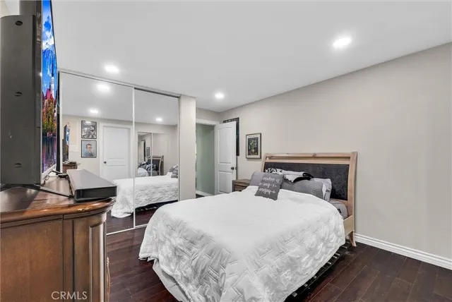 a bedroom with bed and a night stand